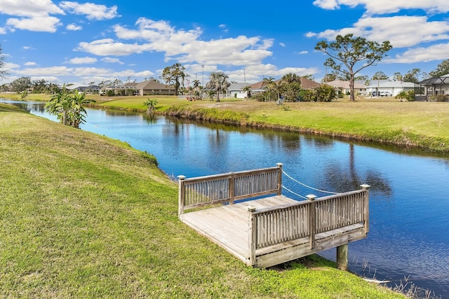 dock area featuring a yard and a water view