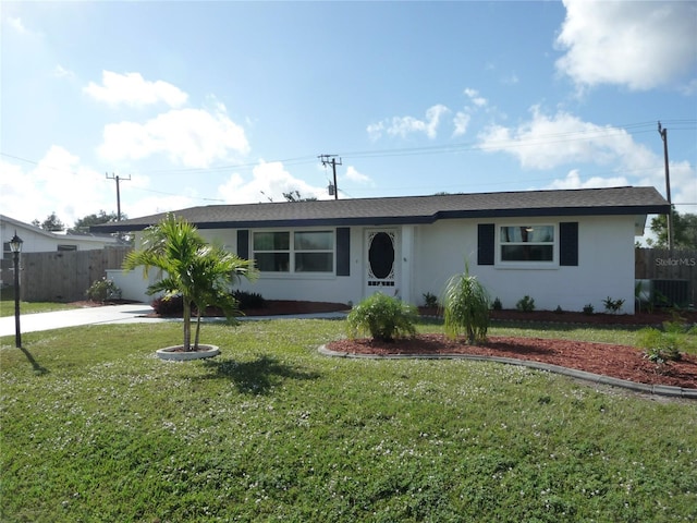 single story home featuring a front lawn