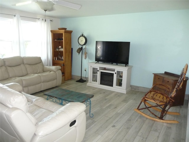 living room with light hardwood / wood-style floors and ceiling fan