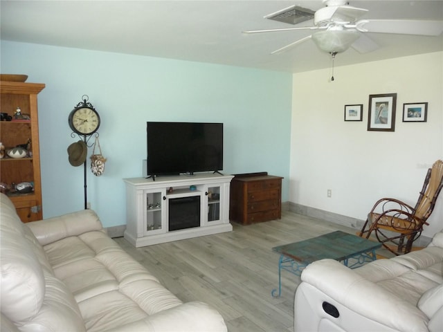 living room featuring ceiling fan and light wood-type flooring