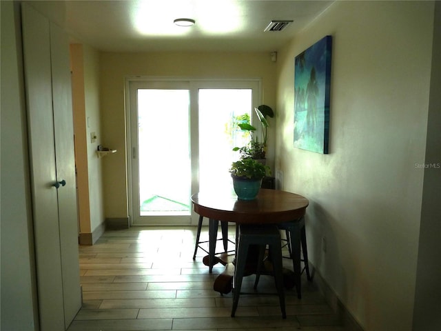 dining space with light hardwood / wood-style flooring