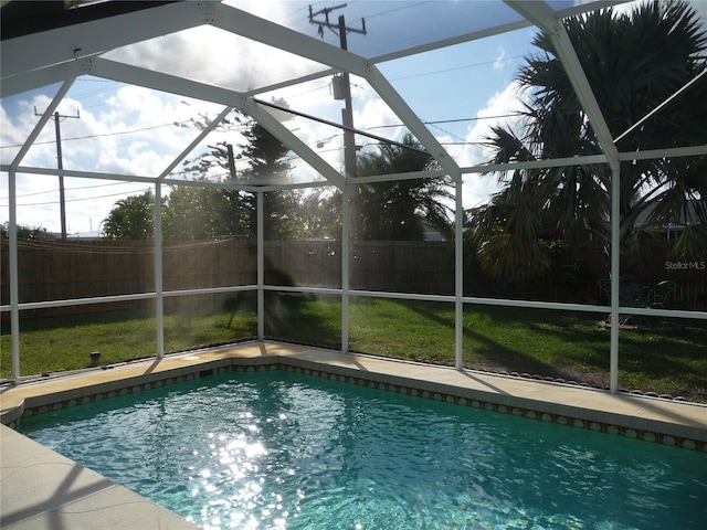 view of pool with a lanai and a yard