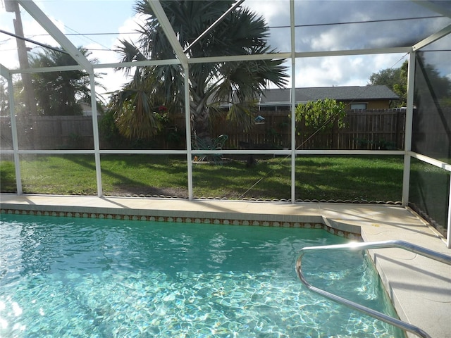 view of swimming pool featuring a patio, a lanai, and a lawn