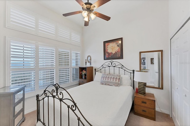 carpeted bedroom with a closet and ceiling fan