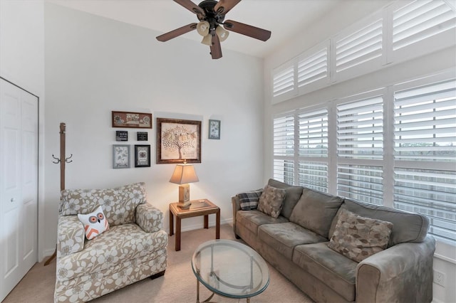 carpeted living room featuring ceiling fan