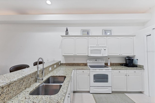 kitchen featuring sink, white cabinetry, light tile patterned floors, white appliances, and light stone countertops