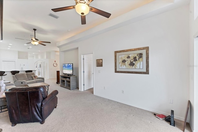 carpeted living room with ceiling fan