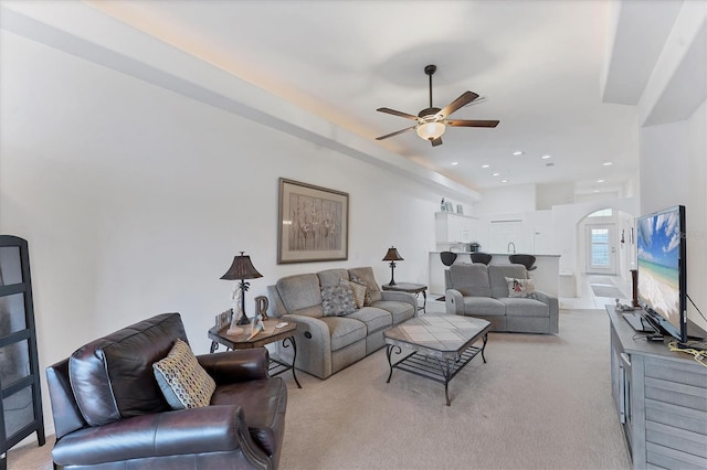 living room with light colored carpet and ceiling fan