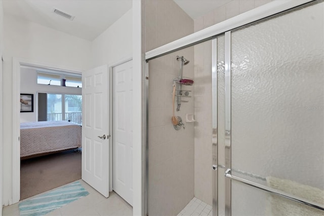 bathroom featuring a shower with shower door