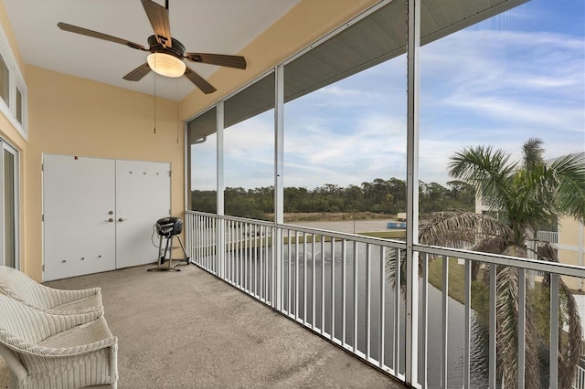 unfurnished sunroom with ceiling fan