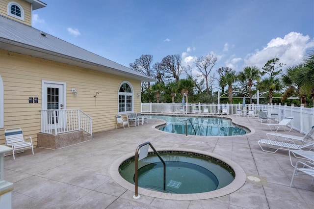 view of swimming pool with an in ground hot tub and a patio area