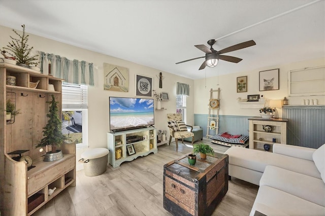 living room with hardwood / wood-style flooring and ceiling fan