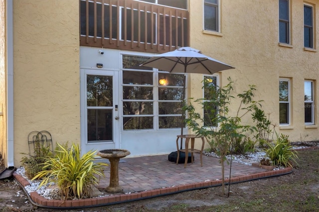 entrance to property with a patio