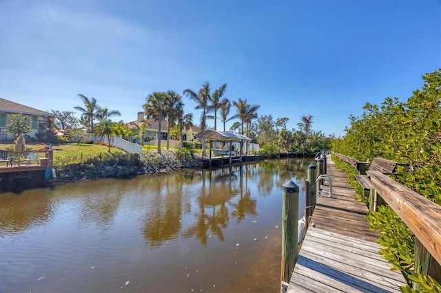 view of dock with a gazebo and a water view