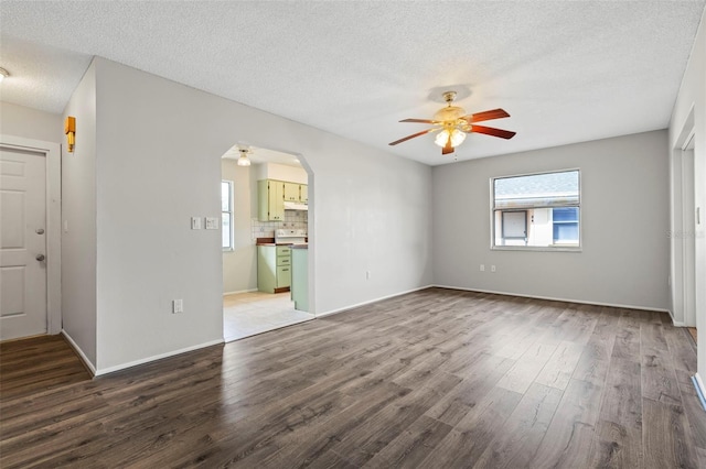 spare room featuring hardwood / wood-style flooring, a textured ceiling, and ceiling fan