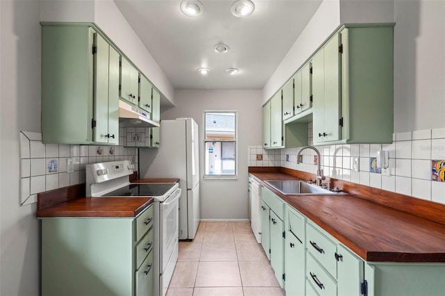 kitchen featuring white range with electric stovetop, sink, decorative backsplash, light tile patterned floors, and green cabinetry