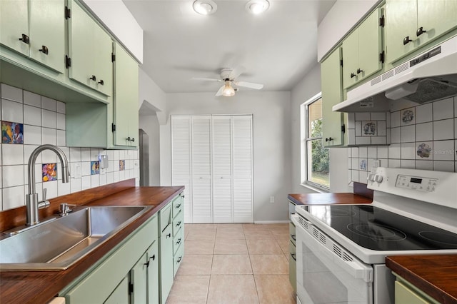 kitchen with white electric stove, sink, wooden counters, light tile patterned floors, and ceiling fan