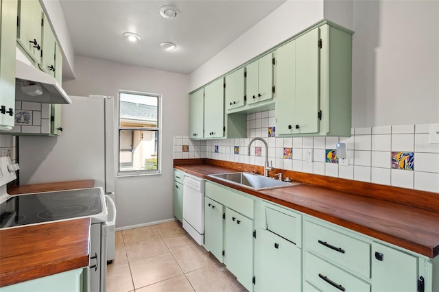 kitchen featuring sink, wooden counters, backsplash, light tile patterned floors, and white appliances