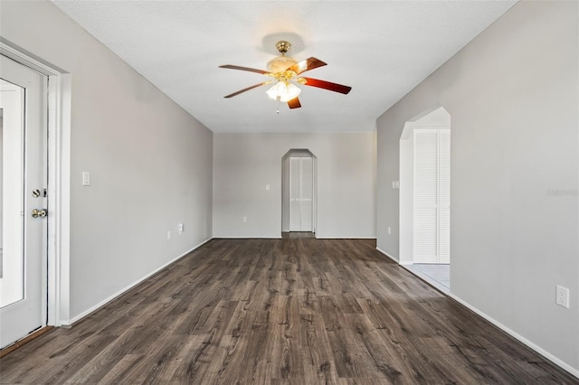 interior space featuring dark hardwood / wood-style flooring, a textured ceiling, and ceiling fan