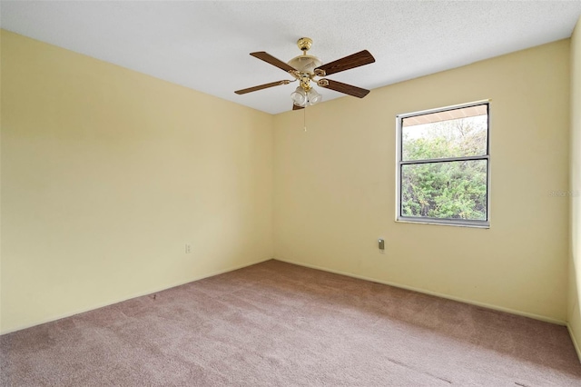 empty room with carpet floors, a textured ceiling, and ceiling fan