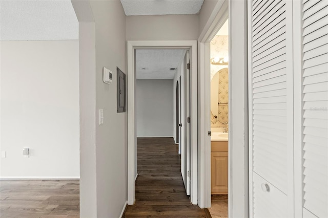 hallway featuring hardwood / wood-style floors and a textured ceiling