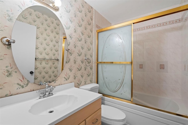 full bathroom featuring enclosed tub / shower combo, vanity, and toilet