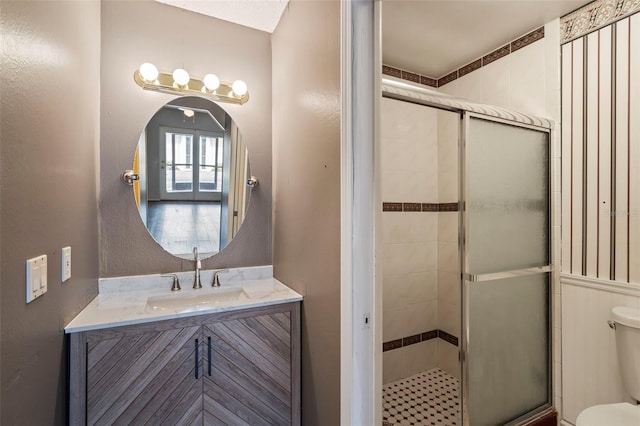 bathroom featuring vanity, toilet, and walk in shower