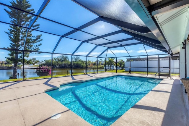 view of swimming pool with a lanai, a patio, and a water view