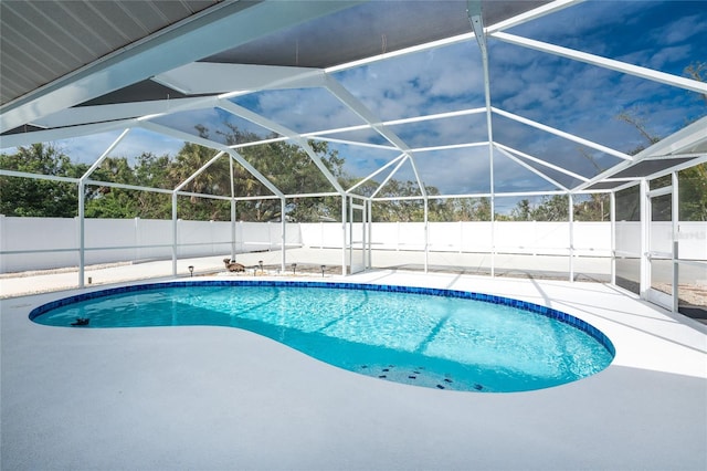 view of swimming pool featuring a patio and a lanai