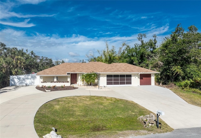 single story home featuring a garage and a front yard