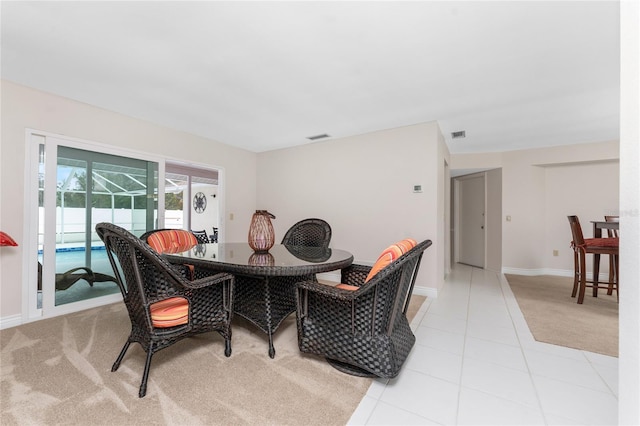 dining room with light colored carpet