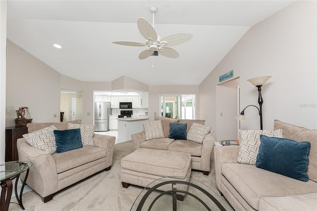 living room featuring lofted ceiling, light colored carpet, and ceiling fan