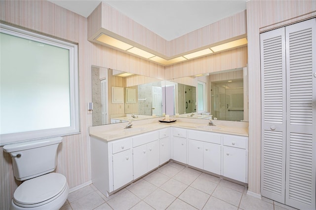 bathroom with vanity, walk in shower, tile patterned floors, and toilet