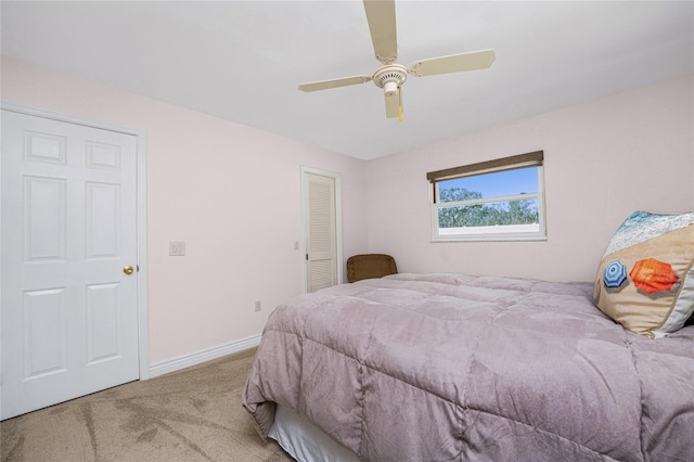 bedroom featuring ceiling fan, a closet, and carpet