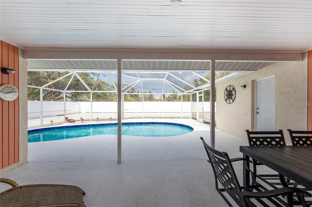 view of pool with a patio and glass enclosure