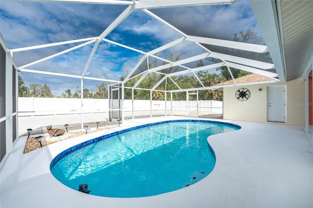 view of pool featuring a patio and glass enclosure