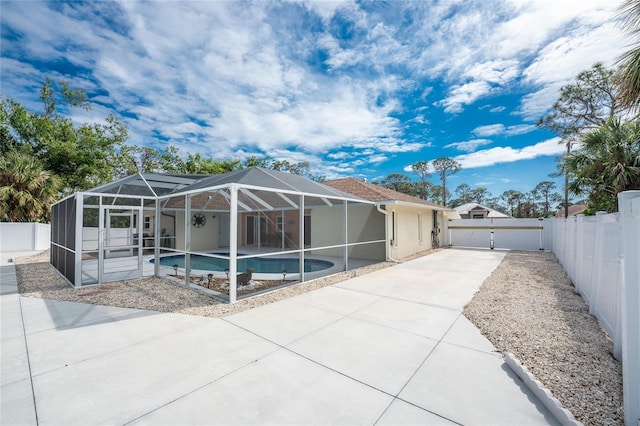 view of pool with a patio and glass enclosure