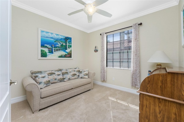 living area with ceiling fan, ornamental molding, and light carpet