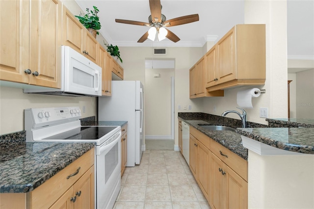 kitchen featuring ornamental molding, sink, dark stone countertops, and white appliances