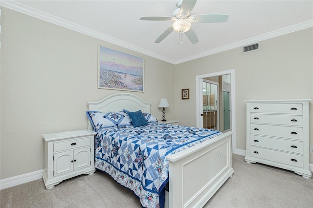 carpeted bedroom featuring crown molding, ensuite bath, and ceiling fan