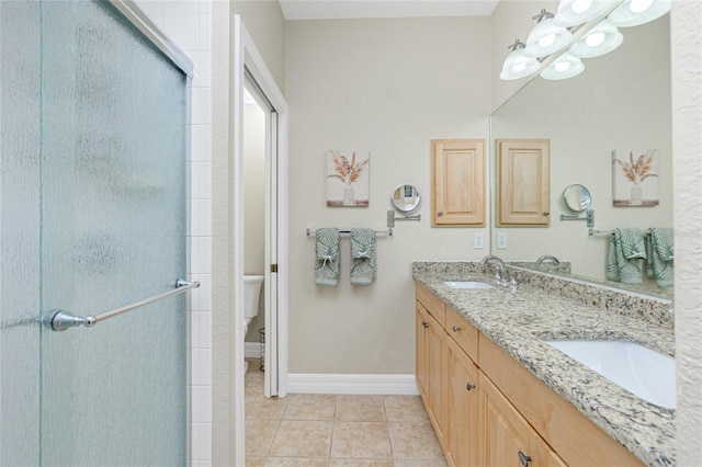 bathroom with tile patterned floors, toilet, a shower with door, and vanity