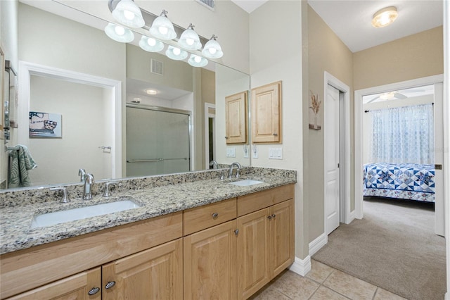 bathroom with an enclosed shower, vanity, tile patterned floors, and ceiling fan