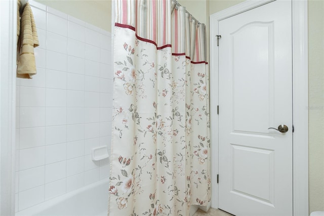 bathroom with shower / bath combo with shower curtain