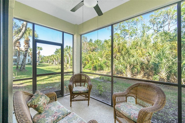 sunroom / solarium featuring ceiling fan