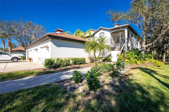 view of side of home with a lawn