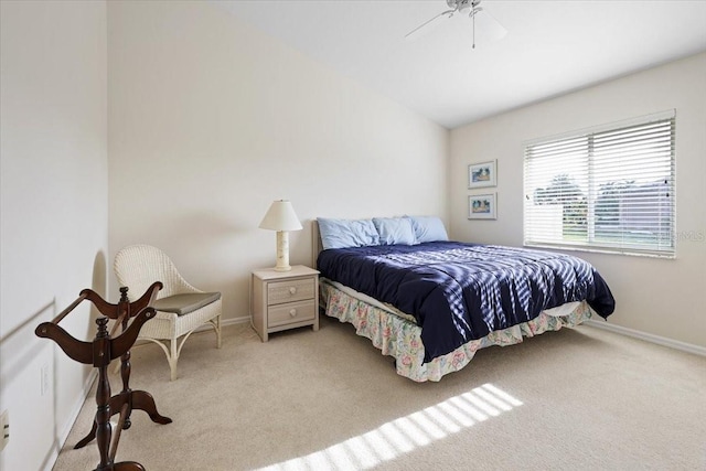 bedroom featuring light carpet, a ceiling fan, baseboards, and vaulted ceiling