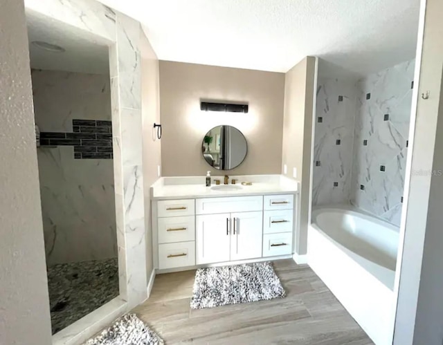 bathroom featuring vanity, hardwood / wood-style floors, and plus walk in shower