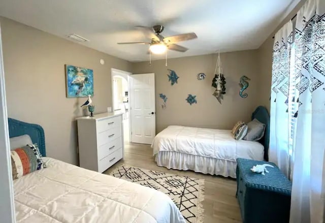 bedroom with light hardwood / wood-style floors and ceiling fan