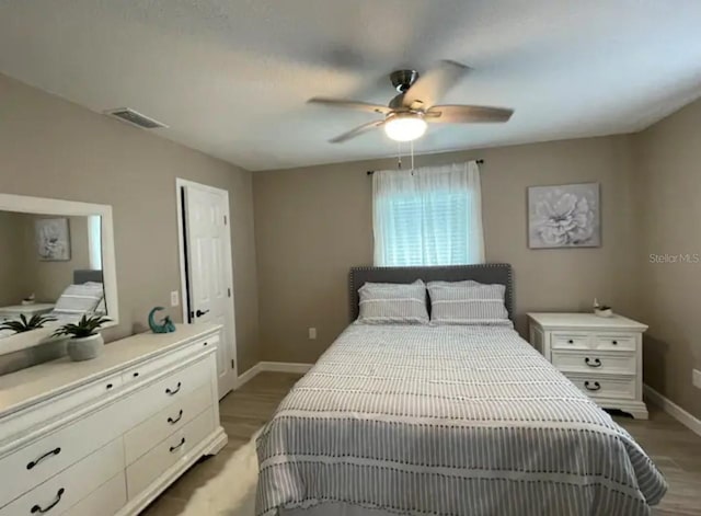 bedroom featuring ceiling fan and light hardwood / wood-style flooring