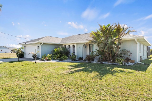 ranch-style home featuring a garage and a front lawn